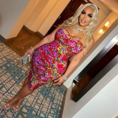 Kimbella is wearing a floral themed dress.